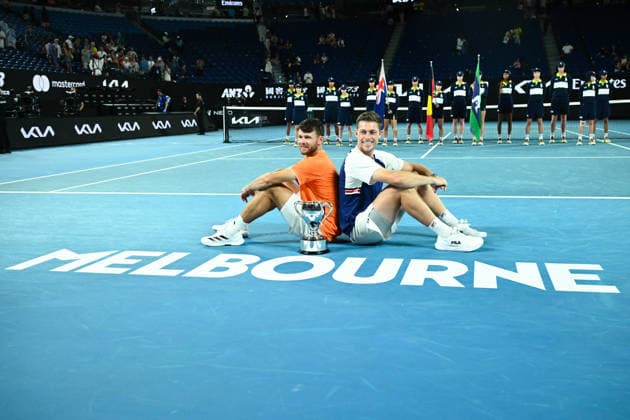 TENNIS AUSTRALIAN OPEN, Christian Harrison (orange) of the USA and Neal Skupski (blue) of Great Britian pose with the winners trophy after winning the men™s doubles final against Jason Kubler (pink) and Marc Polmans (red) of Australia on day 14 of the 2026 Australian Open tennis tournament at Melbourne Park in Melbourne, Saturday, January 31, 2026. ( NO ARCHIVING MELBOURNE VICTORIA AUSTRALIA  Copyright: xJOELxCARRETTx 20260131168926531700