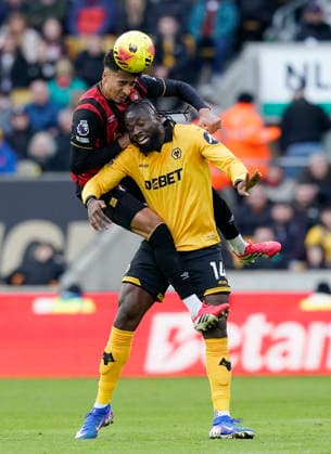 Wolverhampton, England, 31st January 2026. James Hill of Bournemouth tussles with Tolu Arokodare of Wolverhampton Wanderers during the Wolverhampton Wanderers vs AFC Bournemouth Premier League match at Molineux, Wolverhampton. Picture credit should read: Andrew Yates Sportimage EDITORIAL USE ONLY. No use with unauthorised audio, video, data, fixture lists, club league logos or live services. Online in-match use limited to 120 images, no video emulation. No use in betting, games or single club league player publications. SPI_025_AY_Wolves_Bmouth SPI-4493-0025