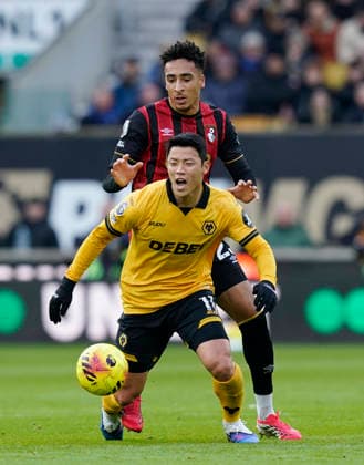 Wolverhampton, England, 31st January 2026. Hee Chan Hwang of Wolverhampton Wanderers tackled by James Hill of Bournemouth during the Wolverhampton Wanderers vs AFC Bournemouth Premier League match at Molineux, Wolverhampton. Picture credit should read: Andrew Yates Sportimage EDITORIAL USE ONLY. No use with unauthorised audio, video, data, fixture lists, club league logos or live services. Online in-match use limited to 120 images, no video emulation. No use in betting, games or single club league player publications. SPI_029_AY_Wolves_Bmouth SPI-4493-0030