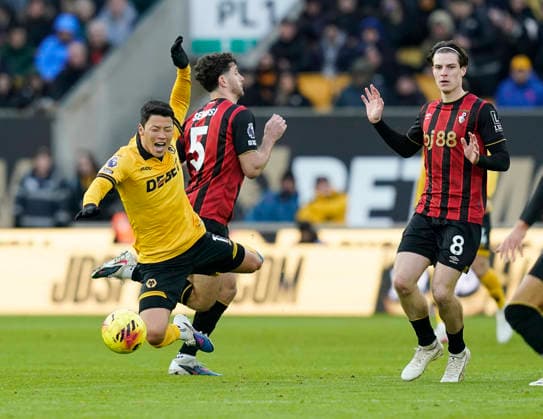 Wolverhampton, England, 31st January 2026. Hee Chan Hwang of Wolverhampton Wanderers tackled by Marcos Senesi of Bournemouth during the Wolverhampton Wanderers vs AFC Bournemouth Premier League match at Molineux, Wolverhampton. Picture credit should read: Andrew Yates Sportimage EDITORIAL USE ONLY. No use with unauthorised audio, video, data, fixture lists, club league logos or live services. Online in-match use limited to 120 images, no video emulation. No use in betting, games or single club league player publications. SPI_045_AY_Wolves_Bmouth SPI-4493-0043