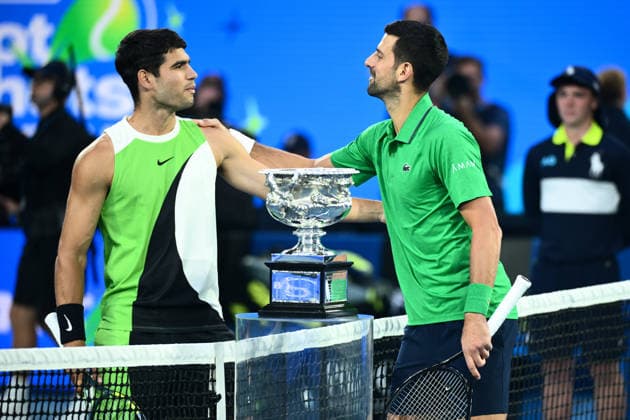 TENNIS AUSTRALIAN OPEN, Carlos Alcaraz of Spain and Novak Djokovic of Serbia pose for photographs at the net during the men™s singles final against Novak Djokovic of Serbia on day 15 of the 2026 Australian Open tennis tournament at Melbourne Park in Melbourne, Sunday, February 1, 2026. ( NO ARCHIVING MELBOURNE VICTORIA AUSTRALIA  Copyright: xJOELxCARRETTx 20260201128327830685