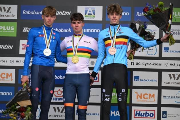 L-R, silver medalist Italian Filippo Grigolini, winner Dutch Delano Heeren wearing the world champion jersey and bronze medalist Belgian Giel Lejeune celebrate on the podium of the junior men race at UCI Cyclocross World Championships, on Sunday 01 February 2026, in Hulst, The Netherlands. DAVIDxPINTENS  x160220870x