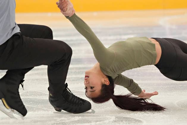 Emily Chan in a death spiral move as her parter Spencer Howe of USA powers the rotation during Pairs Figure skating, Eiskunstlauf practice before the start of the Milan 2026 Winter Olympic Games, Olympische Spiele, Olympia, OS at the Milano Ice Skating Arena in Milan, Italy on Wednesday, February 5, 2026.  OLY20260205112 RichardxEllis