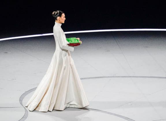 The Italian flag is delivered to the stage during the Opening Ceremony of the Milano Cortina 2026 Olympic Games, Olympische Spiele, Olympia, OS at San Siro Stadium in Milan, Italy, on Friday, February 6, 2026. More than 2,900 athletes from 92 national Olympic committees will compete, with the United States having the largest presence with more than 230 athletes.  OLY20260206113 RICHARDxELLIS