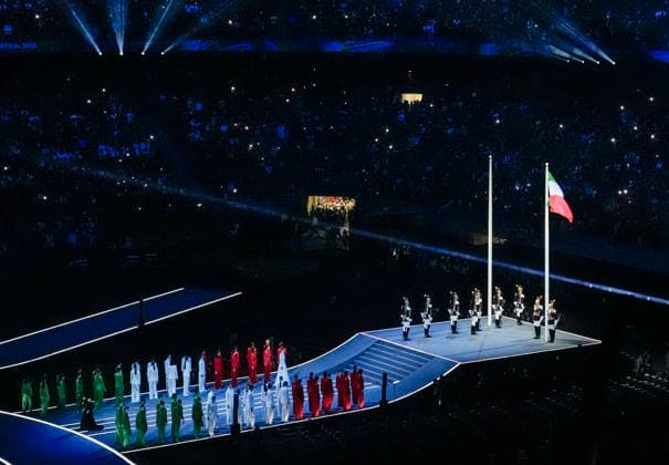 The Italian flag is raised during the Opening Ceremony of the Milano Cortina 2026 Olympic Games, Olympische Spiele, Olympia, OS at San Siro Stadium in Milan, Italy, on Friday, February 6, 2026. More than 2,900 athletes from 92 national Olympic committees will compete, with the United States having the largest presence with more than 230 athletes.  OLY20260206116 RICHARDxELLIS