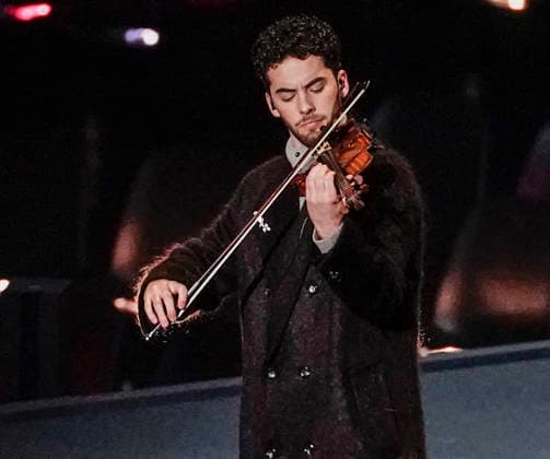 Giovanni Andrea Zanon plays a 1716 Antonio Stradivari violin during the Opening Ceremony of the Milano Cortina 2026 Olympic Games, Olympische Spiele, Olympia, OS at San Siro Stadium in Milan, Italy, on Friday, February 6, 2026. More than 2,900 athletes from 92 national Olympic committees will compete, with the United States having the largest presence with more than 230 athletes.  OLY20260206117 RICHARDxELLIS