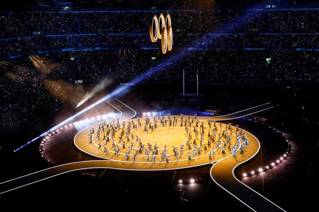 Dancers perform as the Olympic rings are raised during the Opening Ceremony of the Milano Cortina 2026 Olympic Games, Olympische Spiele, Olympia, OS at San Siro Stadium in Milan, Italy, on Friday, February 6, 2026. More than 2,900 athletes from 92 national Olympic committees will compete, with the United States having the largest presence with more than 230 athletes.  OLY20260206325 AARONxJOSEFCZYK