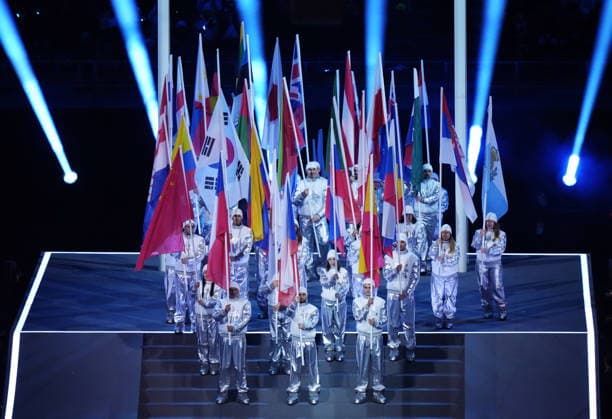 February 6, 2026, Milan, ITALY: Volunteers hold up the competing nations flags during the opening ceremony at the Milan Cortina Winter Olympics, in Milan, on Friday, February 6, 2026. Canada News - February 6, 2026  - ZUMAc35_ 20260206_zaf_c35_207 Copyright: xNathanxDenettex