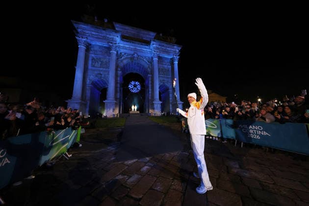 (260207) -- MILAN, Feb. 7, 2026 -- Torchbearers Enrico Fabris passes the Olympic flame during the opening ceremony of the Milan-Cortina 2026 Olympic Winter games, Winterspiele,Spiele, Summer games at the Arco della Pace in Milan, Italy, Feb. 6, 2026. ( Pool via Xinhua) (MICO2026)ITALY-MILAN-CORTINA 2026-OLYMPIC WINTER GAMES-OPENING CEREMONY JamiexSquire 
