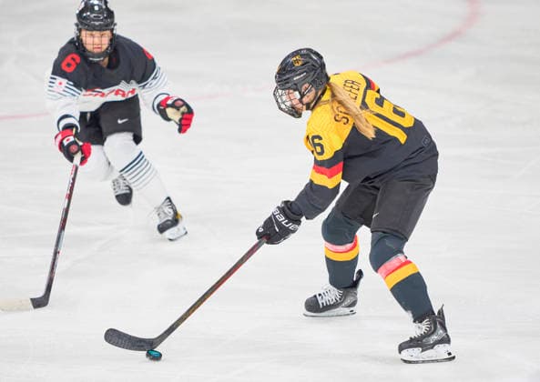 Jule Schiefer of Germany compete and fight for the puck against Kohane Sato of Japan at the preliminary women Ice hockey, Eishockey match Group B Germany-Japan of the Milano Cortina 2026 Winter Olympic Games, Olympische Spiele, Olympia, OS at Milano Rho Ice Hockey Arena on February 7, 2026 in Milan, Italy.