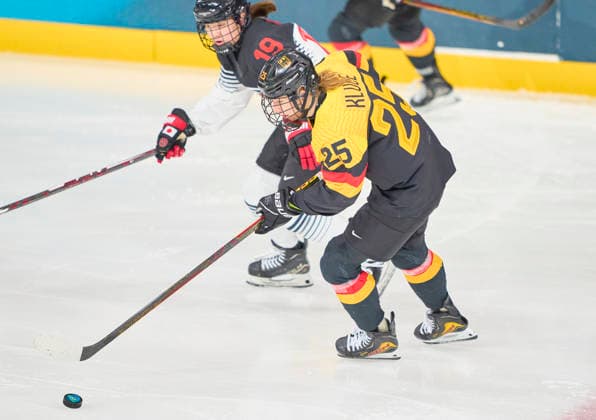 Laura Kluge of Germany compete and fight for the puck against Makoto Ito at the preliminary women Ice hockey, Eishockey match Group B Germany-Japan of the Milano Cortina 2026 Winter Olympic Games, Olympische Spiele, Olympia, OS at Milano Rho Ice Hockey Arena on February 7, 2026 in Milan, Italy.
