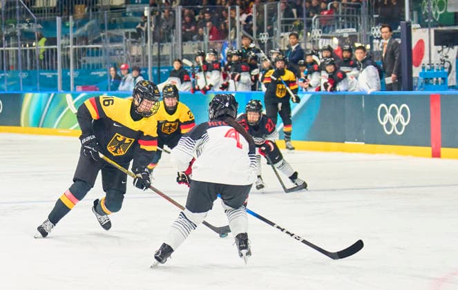 Jule Schiefer of Germany compete and fight for the puck against Ayaka Hitosato of Japan at the preliminary women Ice hockey, Eishockey match Group B Germany-Japan of the Milano Cortina 2026 Winter Olympic Games, Olympische Spiele, Olympia, OS at Milano Rho Ice Hockey Arena on February 7, 2026 in Milan, Italy.