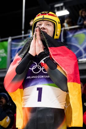 CORTINA, ITALY - FEBRUARY 8: Max Langenhan (Germany) cheers with the German flag after winning Gold during the Luge Men s Singles at the Milano Cortina 2026 Olympics at Cortina Sliding Centre on day 3 of the Milano Cortina 2026 Olympics on February 8, 2026 in Cortina, Italy. Editorial use only. Venezia Italy Copyright: xSteffiexWunderlx