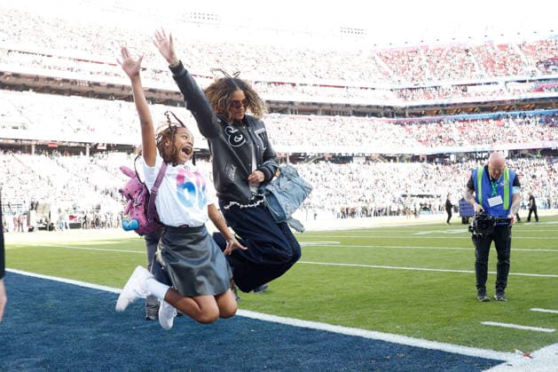 Singer-songwriter Beyonce jumps on the field for a photograph with her daughter before the start of Super Bowl LX at at Levi s Stadium in Santa Clara, California on Sunday, February 8, 2026.  SBP20260208113 JOHNxANGELILLO