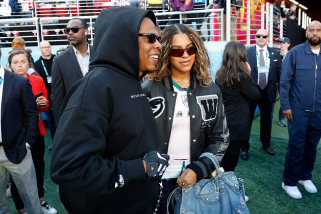 Singer-songwriter Beyonce, right, and Jay Z, left, pose on the field before the start of Super Bowl LX at at Levi s Stadium in Santa Clara, California on Sunday, February 8, 2026.  SBP20260208118 JOHNxANGELILLO