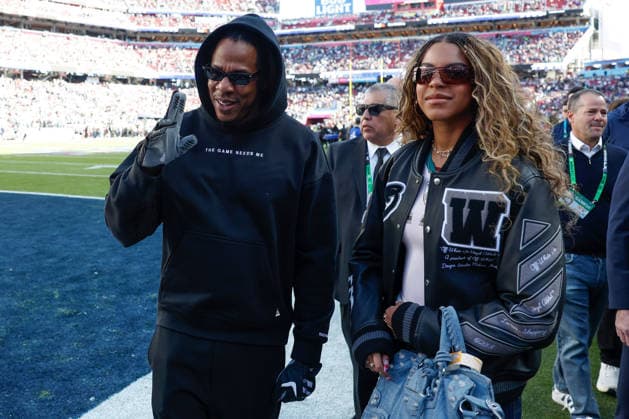 Singer-songwriter Beyonce, right, and Jay Z, left, walk on the field before the start of Super Bowl LX at at Levi s Stadium in Santa Clara, California on Sunday, February 8, 2026.  SBP20260208114 JOHNxANGELILLO