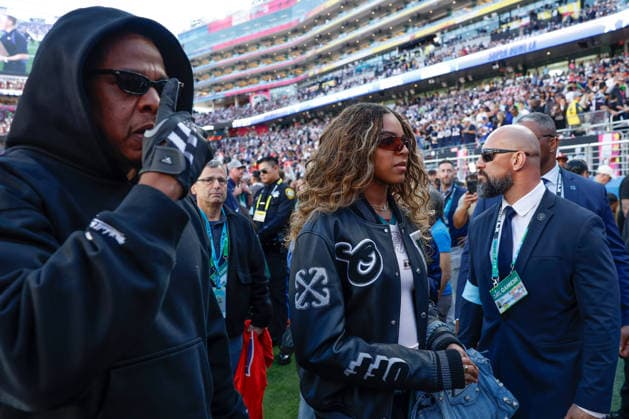 Singer-songwriter Beyonce, right, and Jay Z, left, walk on the field before the start of Super Bowl LX at at Levi s Stadium in Santa Clara, California on Sunday, February 8, 2026.  SBP20260208115 JOHNxANGELILLO