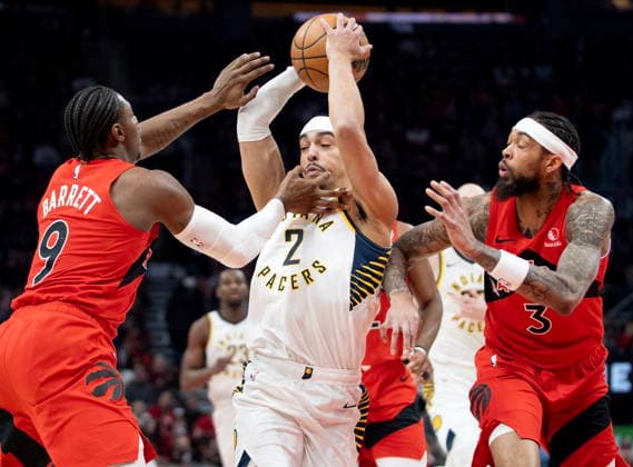 February 8, 2026, Toronto, On, Canada: Indiana Pacers guard Andrew Nembhard (2) is double teamed by Toronto Raptors Brandon Ingram (3) and R.J. Barrett (9) as he drives to the hoop during first half NBA, Basketball Herren, USA action in Toronto on Sunday Feb. 8, 2026. Canada News - February 8, 2026  - ZUMAc35_ 20260208_zaf_c35_198 Copyright: xFrankxGunnx