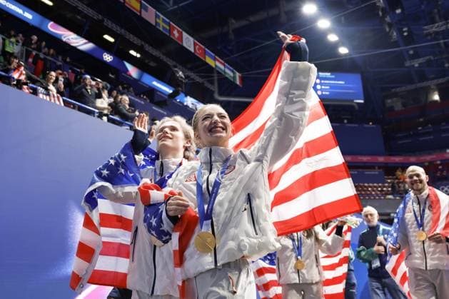 Milan Cortina Olympics: Figure skating, Eiskunstlauf Ilia Malinin (L) and Amber Glenn of the United States wave to the crowd after winning the figure skating team event at the Milan Cortina Olympics at Milano Ice Skating Arena in Milan on Feb. 8, 2026.  A14AA0005258946P