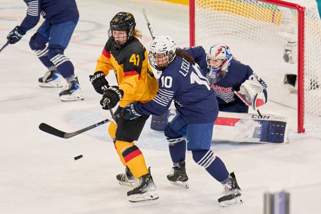 Mathilda Heine of Germany compete and fight for the puck against Sophie LeClerc of France at the preliminary women Ice hockey, Eishockey match Group B Germany - France of the Milano Cortina 2026 Winter Olympic Games, Olympische Spiele, Olympia, OS at Milano Rho Ice Hockey Arena on February 9, 2026 in Milan, Italy.