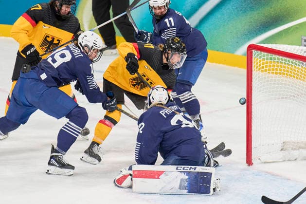 Nicola Hadraschek- Eisenschmid of Germany Emily Nix of Germany compete and fight for the puck against Alice Philbert of France Lore Baudrit of France at the preliminary women Ice hockey, Eishockey match Group B Germany - France of the Milano Cortina 2026 Winter Olympic Games, Olympische Spiele, Olympia, OS at Milano Rho Ice Hockey Arena on February 9, 2026 in Milan, Italy.