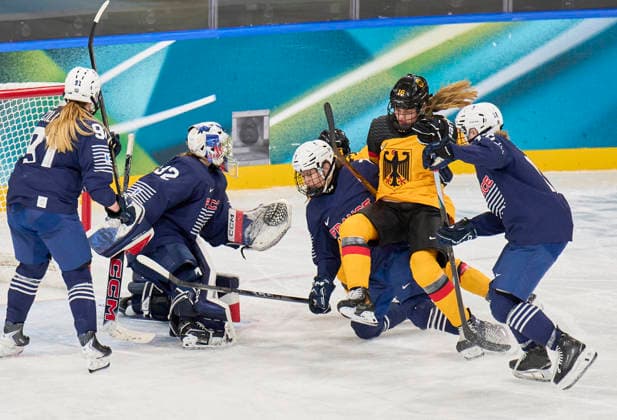 Jule Schiefer of Germany shoulder injury compete and fight for the puck against Lucie Quarto of France at the preliminary women Ice hockey, Eishockey match Group B Germany - France of the Milano Cortina 2026 Winter Olympic Games, Olympische Spiele, Olympia, OS at Milano Rho Ice Hockey Arena on February 9, 2026 in Milan, Italy.