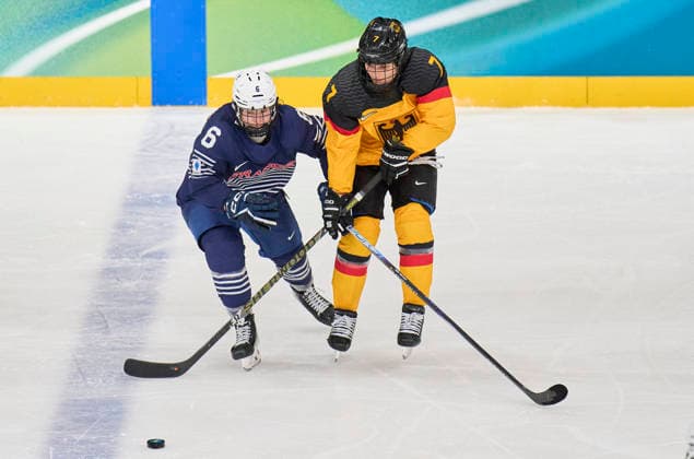 Franziska Feldmeier of Germany compete and fight for the puck against Margot Huot-Marchand of France at the preliminary women Ice hockey, Eishockey match Group B Germany - France of the Milano Cortina 2026 Winter Olympic Games, Olympische Spiele, Olympia, OS at Milano Rho Ice Hockey Arena on February 9, 2026 in Milan, Italy.