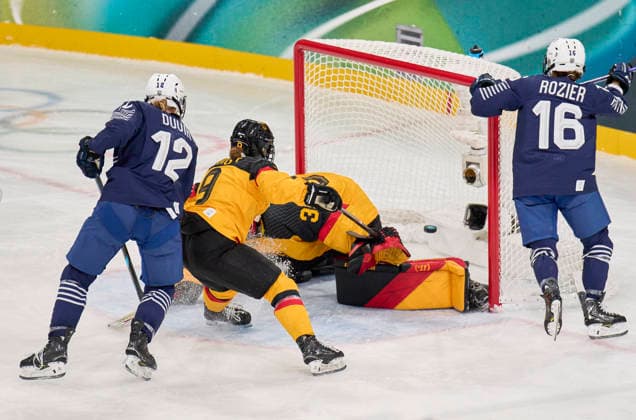 Estelle Duvin of France scores for 1-1, shoots goal , Tor, Treffer, Torschuss, against Sandra Abstreiter of Germany Svenja Voigt of Germany at the preliminary women Ice hockey, Eishockey match Group B Germany - France of the Milano Cortina 2026 Winter Olympic Games, Olympische Spiele, Olympia, OS at Milano Rho Ice Hockey Arena on February 9, 2026 in Milan, Italy.