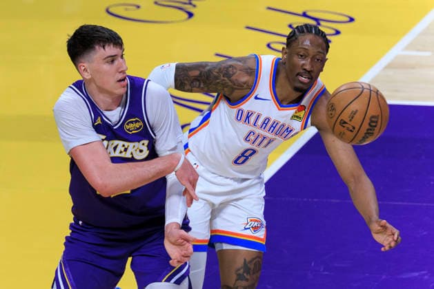 February 9, 2026, Los Angeles, California, USA: Jake LaRavia 12 of the Los Angeles Lakers keeps the ball in bounds as Jalen Williams 8 of the Oklahoma City Thunder attempts to intercept during their regular season NBA, Basketball Herren, USA game on Monday February 9, 2026 at Crypto.com Arena in Los Angeles, California. ARIANA RUIZ PI Los Angeles USA - ZUMAp124 20260209_zaa_p124_006 Copyright: xArianaxRuizx