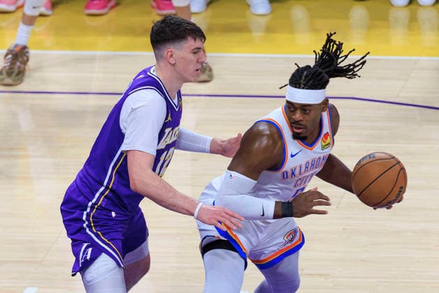February 9, 2026, Los Angeles, California, USA: Jake LaRavia 12 of the Los Angeles Lakers guards Luguentz Dort 5 of the Oklahoma City Thunder during their regular season NBA, Basketball Herren, USA game on Monday February 9, 2026 at Crypto.com Arena in Los Angeles, California. ARIANA RUIZ PI Los Angeles USA - ZUMAp124 20260209_zaa_p124_010 Copyright: xArianaxRuizx