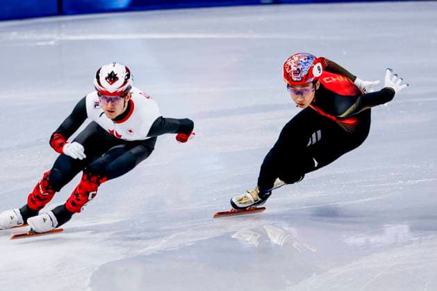 Felix Roussel of Canada and Long Sun of China Mixed Team Relay Quarterfinals, Milano Cortina 2026 Winter Olympics: Day 4, Short Track Speed skating, Eisschnelllauf - Milano Cortina 2026 Winter Olympics: Day 4, Milano Speed Skating Stadium, February 10, 2026, Milan, Italy.