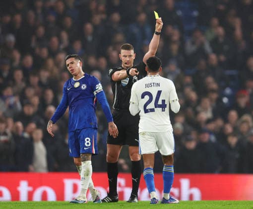 London, England, 10th February 2026. James Justin of Leeds United receives a yellow card from referee Robert Jones during the Chelsea vs Leeds United Premier League match at Stamford Bridge, London. Picture credit should read: Paul Terry Sportimage EDITORIAL USE ONLY. No use with unauthorised audio, video, data, fixture lists, club league logos or live services. Online in-match use limited to 120 images, no video emulation. No use in betting, games or single club league player publications. SPI_028_PT_Chelsea_v_Leeds_United SPI-4517-0029