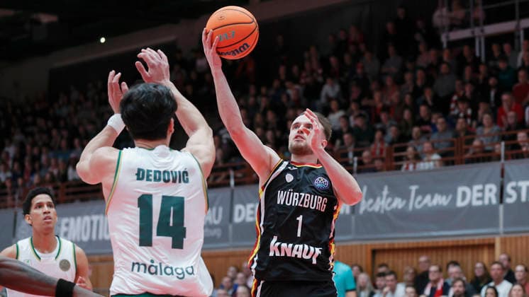 In the picture from left Nihad Dedovic Unicaja Malaga, 14 against Lukas Herzog Wuerzburg Baskets, 1 11 02 2026, Fitness First Wuerzburg Baskets vs Unicaja Malaga, Basketball Champions League, Round of 16, Group K, Matchday 4, Germany, 97072, tectake Arena Wuerzburg, Copyright: HMBxMedia xJulienxBecker