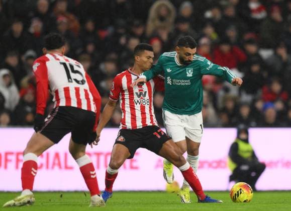 Reinildo Mandava of Sunderland challenges Mohamed Salah of Liverpool Sunderland v Liverpool, Premier League, Football, Stadium of Light, Sunderland, UK - 11 Feb 2026Sunderland Stadium of Light United Kingdom EDITORIAL USE ONLY No use with unauthorised audio, video, data, fixture lists, club league logos or live services. Online in-match use limited to 120 images, no video emulation. No use in betting, games or single club league player publications. Copyright: xRichardxLee Shutterstockx 16540365f