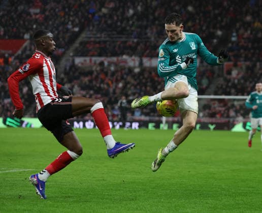 Sunderland, England, 11th February 2026. Nordi Mukiele (L) of Sunderland in action with Florian Wirtz of Liverpool during the Sunderland vs Liverpool Premier League match at the Stadium Of Light, Sunderland. Picture credit should read: Nigel Roddis Sportimage EDITORIAL USE ONLY. No use with unauthorised audio, video, data, fixture lists, club league logos or live services. Online in-match use limited to 120 images, no video emulation. No use in betting, games or single club league player publications. SPI_017_NR_SUND_LIVE SPI-4522-0015