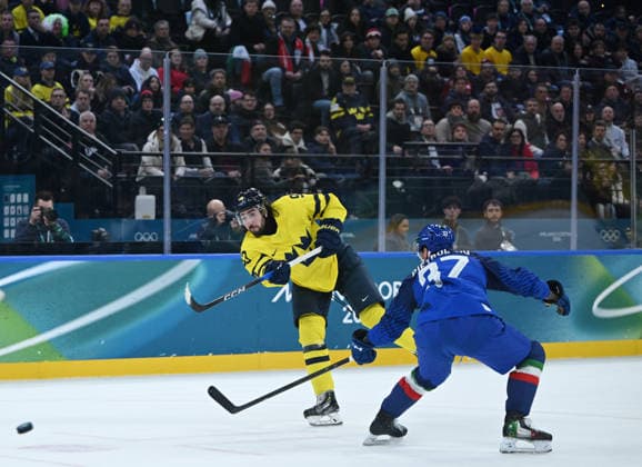 (260212) -- MILAN, Feb. 12, 2026 -- Mika Zibanejad (L) of Sweden shoots during the Ice hockey, Eishockey men s preliminary round group B match between Italy and Sweden at the Milan-Cortina 2026 Olympic Winter games, Winterspiele,Spiele, Summer games in Milan, Italy, Feb. 11, 2026. ) (MICO2026)ITALY-MILAN-OLYMPIC WINTER GAMES-ICE HOCKEY-MEN-PRELIMINARY-ITA VS SWE ZhangxHaofu 