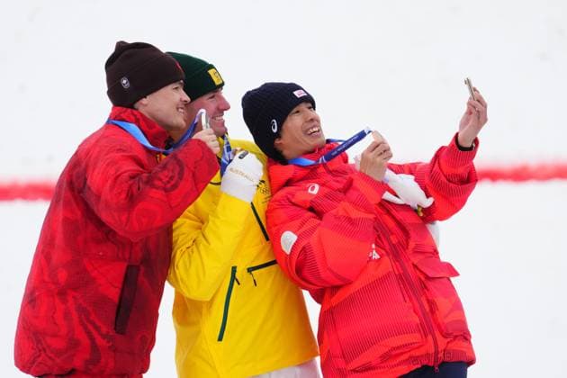 February 12, 2026, Livigno, Italy: From left, silver medalist Canada s Mikael Kingsbury, gold medalist Australia s Cooper Woods and bronze medalist Japan s Ikuma Horishima take a selfie after the men s freestyle skiing moguls finals at the 2026 Winter Olympics, in Livigno, Italy, Thursday, Feb. 12, 2026. CANADIAN PRESS Canada News - February 12, 2026  - ZUMAc35_ 20260212_zaf_c35_036 Copyright: xSeanxKilpatrickx