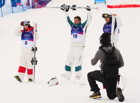 February 12, 2026, Livigno, Italy: From left, silver medalist Canada s Mikael Kingsbury, gold medalist Australia s Cooper Woods and bronze medalist Japan s Ikuma Horishima celebrate after the men s freestyle skiing moguls finals at the 2026 Winter Olympics, in Livigno, Italy, Thursday, Feb. 12, 2026. Canada News - February 12, 2026  - ZUMAc35_ 20260212_zaf_c35_040 Copyright: xSeanxKilpatrickx