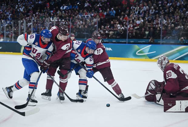 (260213) -- MILAN, Feb. 13, 2026 -- Elvis Merzlikins (1st R) of Latvia makes a save during the Ice hockey, Eishockey men s preliminary round group C match between the United States and Latvia at the Milan-Cortina 2026 Olympic Winter games, Winterspiele,Spiele, Summer games in Milan, Italy, Feb. 12, 2026. ) (MICO2026)ITALY-MILAN-OLYMPIC WINTER GAMES-ICE HOCKEY-MEN-PRELIMINARY-USA VS LAT ZhangxHaofu 