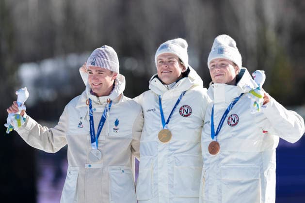 OLYMPICS - Winter Olympic Games, Olympische Spiele, Olympia, OS Milano Cortina 2026 TESERO,ITALY,13.FEB.26 - OLYMPICS, NORDIC SKIING, CROSS COUNTRY SKIING - Winter Olympic Games Milano Cortina 2026, 10km men, interval start free, medal ceremony. Image shows the rejoicing of Mathis Desloges (FRA), Johannes Hoesflot Klaebo (NOR) and Einar Hedegart (NOR).  GEPAxpictures xMatthiasxTrinkl