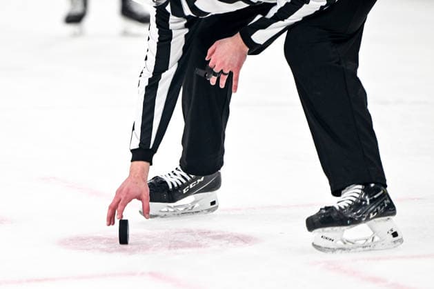 MILAN, ITALY - FEBRUARY 13: A referee picks up the puck during the Men™s Prelim Round match between Finland and Sweden on day seven of the Milano Cortina 2026 Winter Olympic Games, Olympische Spiele, Olympia, OS at Milano Santagiulia IHO Arena on February 13, 2026 in Milan, Italy. Milan Milano Santagiulia IHO Arena Italy *** MILAN, ITALY FEBRUARY 13 A referee picks up the puck during the Men™s Prelim Round match between Finland and Sweden on day seven of the Milano Cortina 2026 Winter Olympic games at Milano Santagiulia IHO Arena on February 13, 2026 in Milan, Italy Milan Milano Santagiulia IHO Arena Italy Copyright: xJustPictures.ch AndreaxBrancax jp-en-EuSpIm-AB-AAB_209013022026