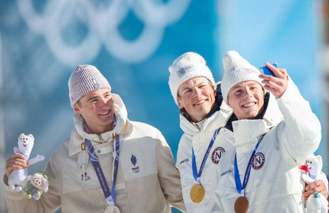 ITALY, TESERO - FEBRUARY 13, 2026: Johannes Hoesflot Klaebo of Norway, Mathis Desloges of France, and Einar Hedegart (L-R) of Norway celebrate their gold, silver and bronze medals respectively for the men s 10km interval start free race at Tesero Cross-Country Stadium during the 2026 Winter Olympic Games, Olympische Spiele, Olympia, OS Peter Kovalev TASS  88634614