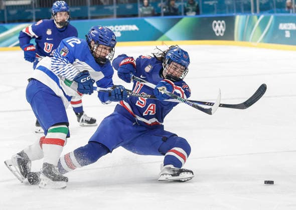 United States Abbey Murphy (37) tries to shoot next to Italy s Rebecca Roccella (12) in the second period of the Women s Playoff Quarterfinal game between Italy and the USA at the Milano Rho Ice hockey, Eishockey Arena in Milan, Italy, on Friday, February 13, 2026.  OLY202602138625 AARONxJOSEFCZYK