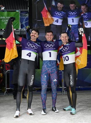(260214) -- CORTINA D AMPEZZO, Feb. 14, 2026 -- Gold medalist Matt Weston (C) of Britain, silver medalist Axel Jungk (L) of Germany and bronze medalist Christopher Grotheer of Germnay celebrate after the skeleton men competition heat 4 at the Milan-Cortina 2026 Olympic Winter games, Winterspiele,Spiele, Summer games in Cortina, Italy, Feb. 13, 2026. ) (MICO2026)ITALY-CORTINA D AMPEZZO-OLYMPIC WINTER GAMES-SKELETON-MEN LianxYi 