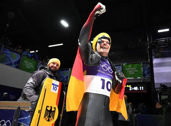 (260214) -- CORTINA D AMPEZZO, Feb. 14, 2026 -- Christopher Grotheer (R) celebrates after his competition during the skeleton men competition heat 4 at the Milan-Cortina 2026 Olympic Winter games, Winterspiele,Spiele, Summer games in Cortina, Italy, Feb. 13, 2026. ) (MICO2026)ITALY-CORTINA D AMPEZZO-OLYMPIC WINTER GAMES-SKELETON-MEN LianxYi 