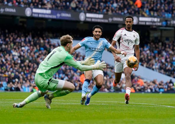 Manchester, England, 14th February 2026. Matt Young of Salford City takes the ball in front of too Omar Marmoush of Manchester City during the Manchester City vs Salford City FA Cup fourth round match at the Etihad Stadium, Manchester. Picture credit should read: Andrew Yates Sportimage EDITORIAL USE ONLY. No use with unauthorised audio, video, data, fixture lists, club league logos or live services. Online in-match use limited to 120 images, no video emulation. No use in betting, games or single club league player publications. SPI_022_AY_Man_City_Salford SPI-4533-0027