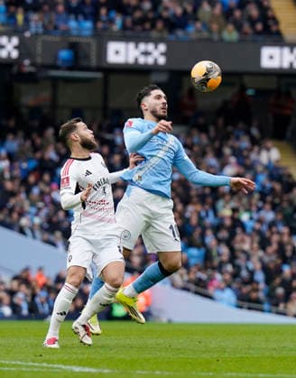 Manchester, England, 14th February 2026. Jorge Grant of Salford City and Rayan Cherki of Manchester City during the Manchester City vs Salford City FA Cup fourth round match at the Etihad Stadium, Manchester. Picture credit should read: Andrew Yates Sportimage EDITORIAL USE ONLY. No use with unauthorised audio, video, data, fixture lists, club league logos or live services. Online in-match use limited to 120 images, no video emulation. No use in betting, games or single club league player publications. SPI_027_AY_Man_City_Salford SPI-4533-0032