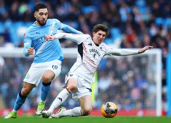 Rayan Cherki of Manchester City and Josh Austerfield of Salford City Manchester City v Salford City, Emirates FA Cup, Fourth Round, Football, Etihad Stadium, Manchester, UK - 14 Feb 2026Manchester Etihad Stadium United Kingdom EDITORIAL USE ONLY No use with unauthorised audio, video, data, fixture lists, club league logos or live services. Online in-match use limited to 120 images, no video emulation. No use in betting, games or single club league player publications. Copyright: xMattxWest Shutterstockx 16608276l