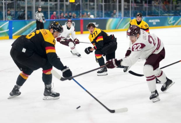 (260214) -- MILAN, Feb. 14, 2026 -- John Peterka (C) of Germany loses his helmet during the Ice hockey, Eishockey men s preliminary round group C match between Germany and Latvia of the Milan-Cortina 2026 Olympic Winter games, Winterspiele,Spiele, Summer games in Milan, Italy, Feb. 14, 2026. ) (MICO2026)ITALY-MILAN-OLYMPIC WINTER GAMES-ICE HOCKEY-MEN-PRELIMINARY-GER VS LAT SunxFei 