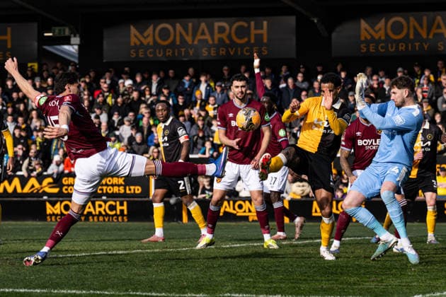 14th February 2026; Pirelli Stadium, Burton, West Staffordshire, England; FA Cup Football, Burton Albion versus West Ham United; Konstantinos Mavropanos of West Ham stretches to connect with the ball ahead of Bradley Collins of Burton Albion  GodfreyxPitt Content restricted for UK based newspaper